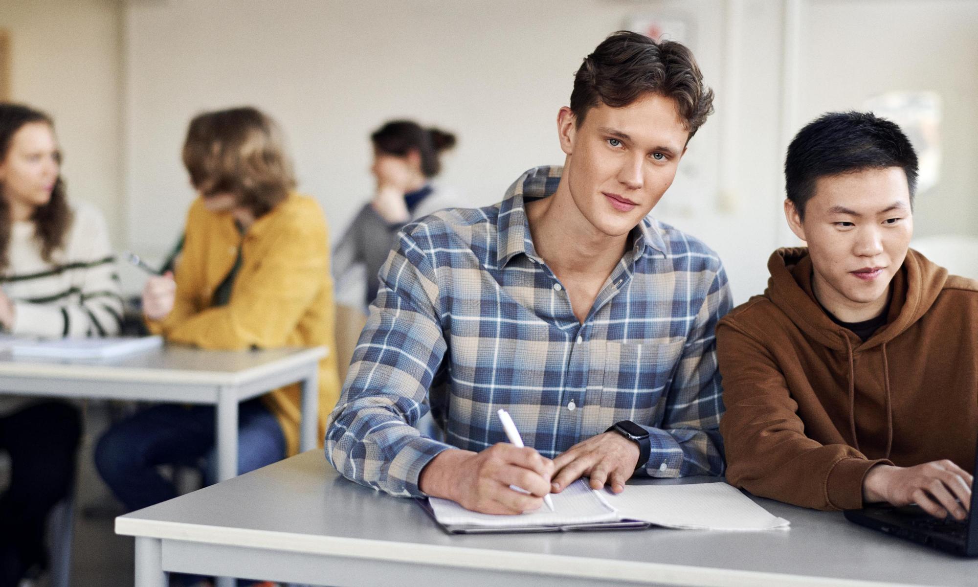 Students studying at a desk in classroom